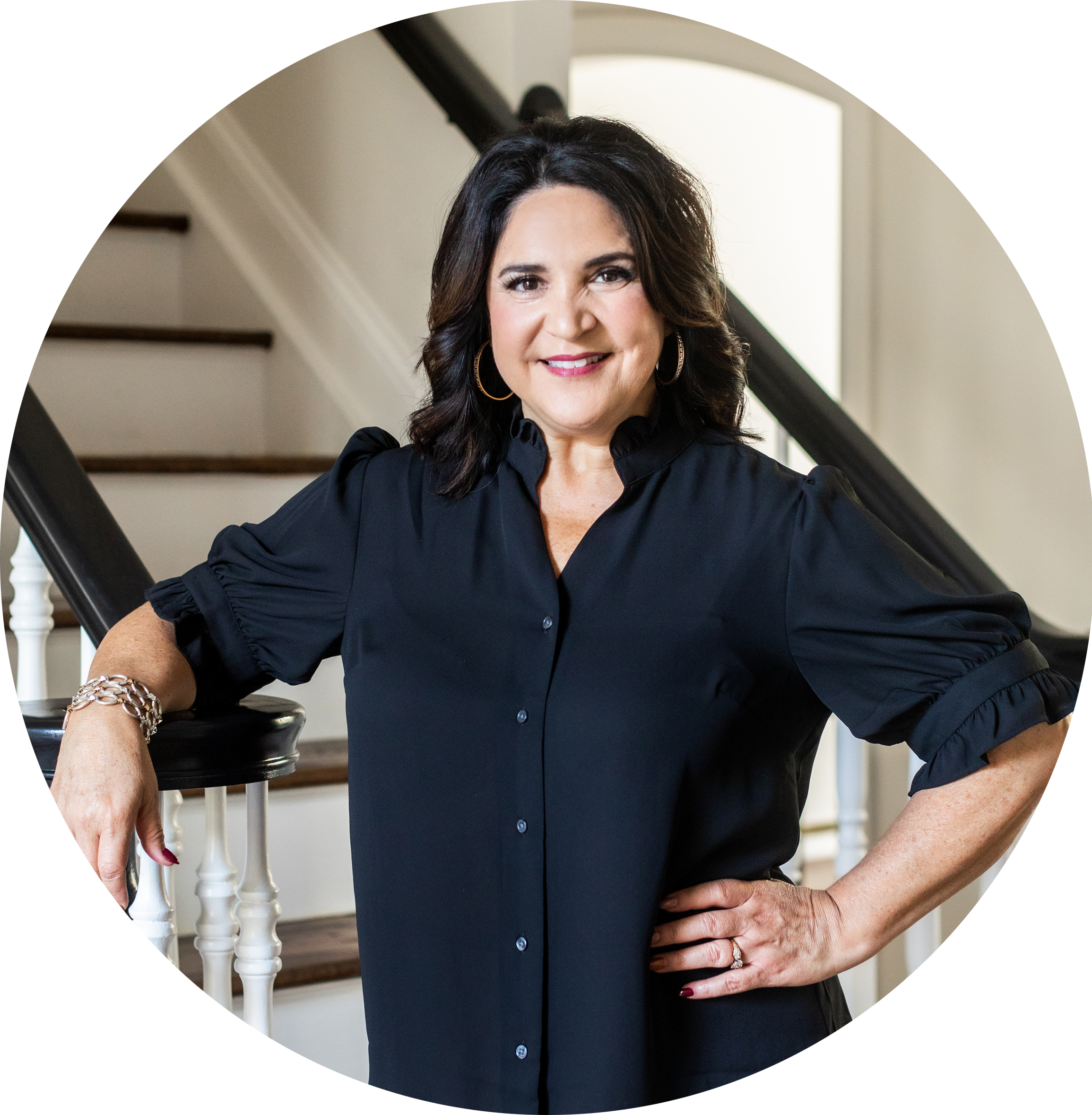 dark haired woman standing at stairs